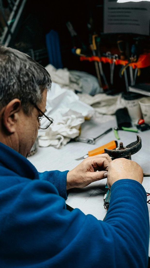 Schreiner in einer Werkstatt zwischen Maschinen und Holz